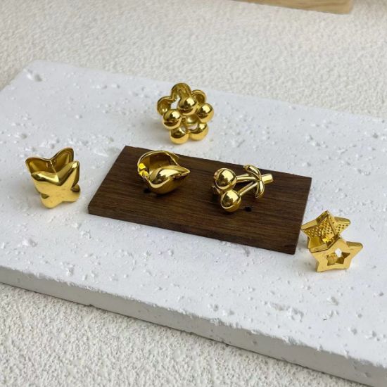 Picture of 18K gold-plated titanium huggies—florals, drops & geo studs